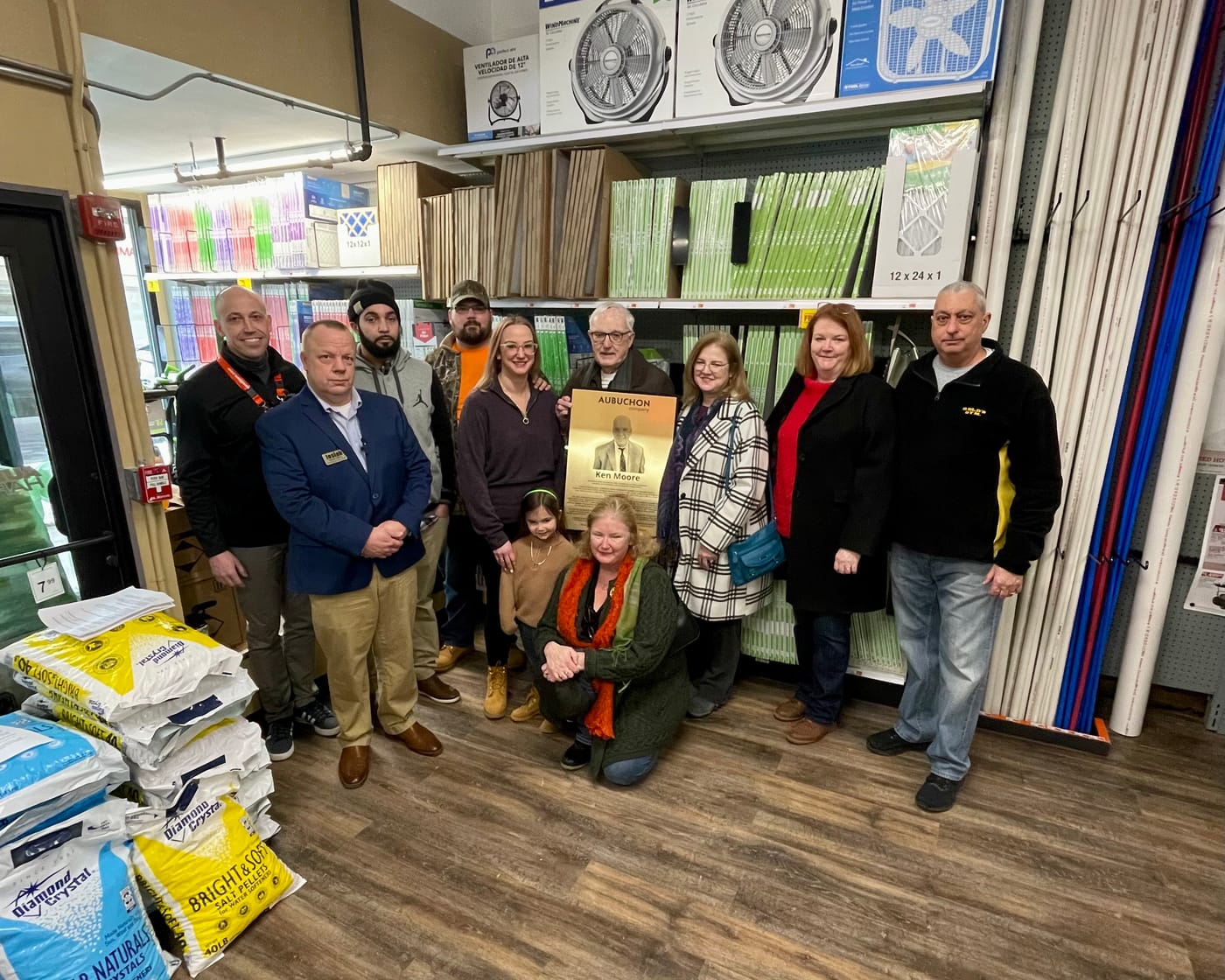 Ken Moore’s family with the store dedication plaque.
