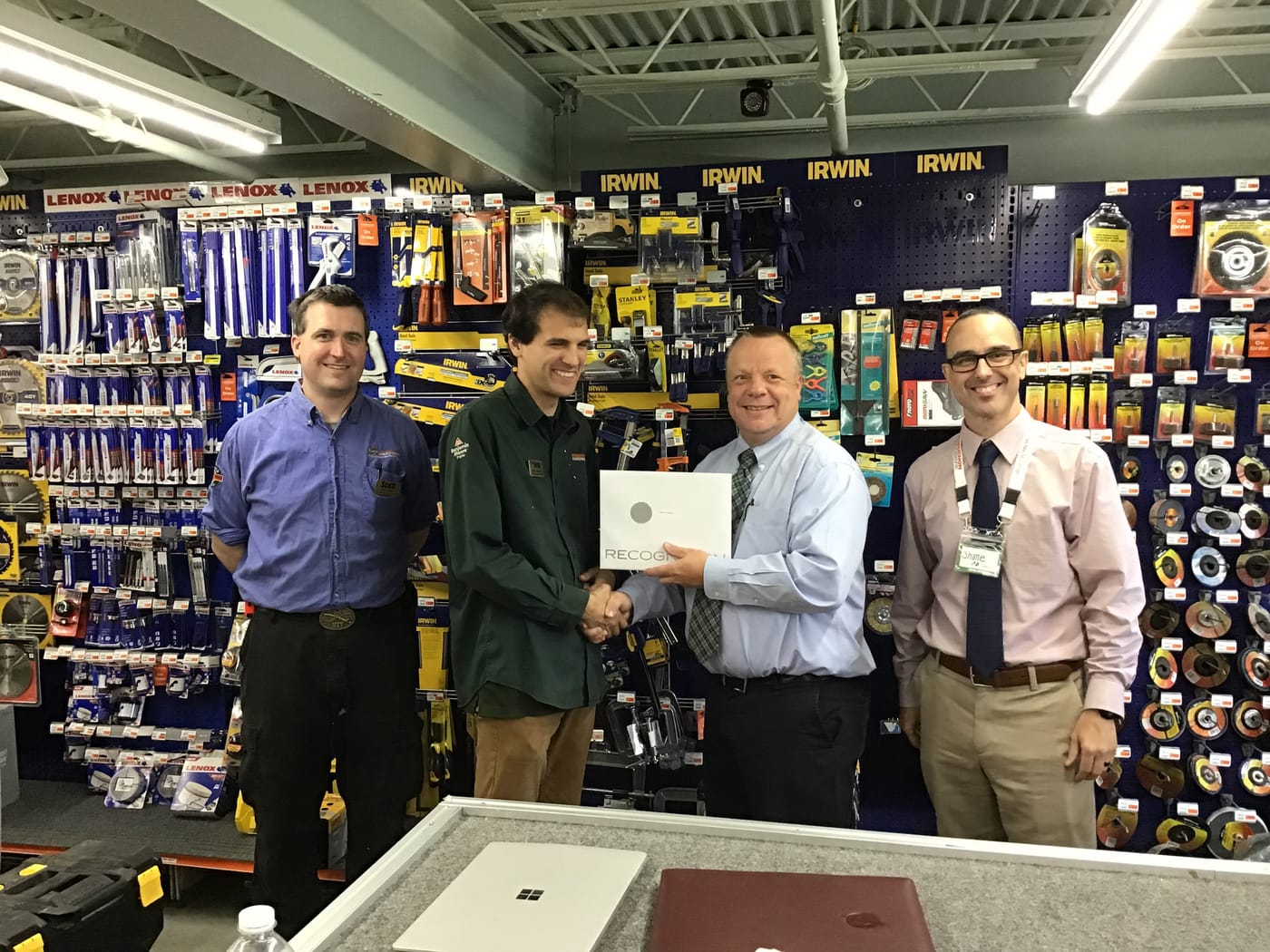 Gates presents a recognition award to team member Adam Champine in Shelburne, Vermont.